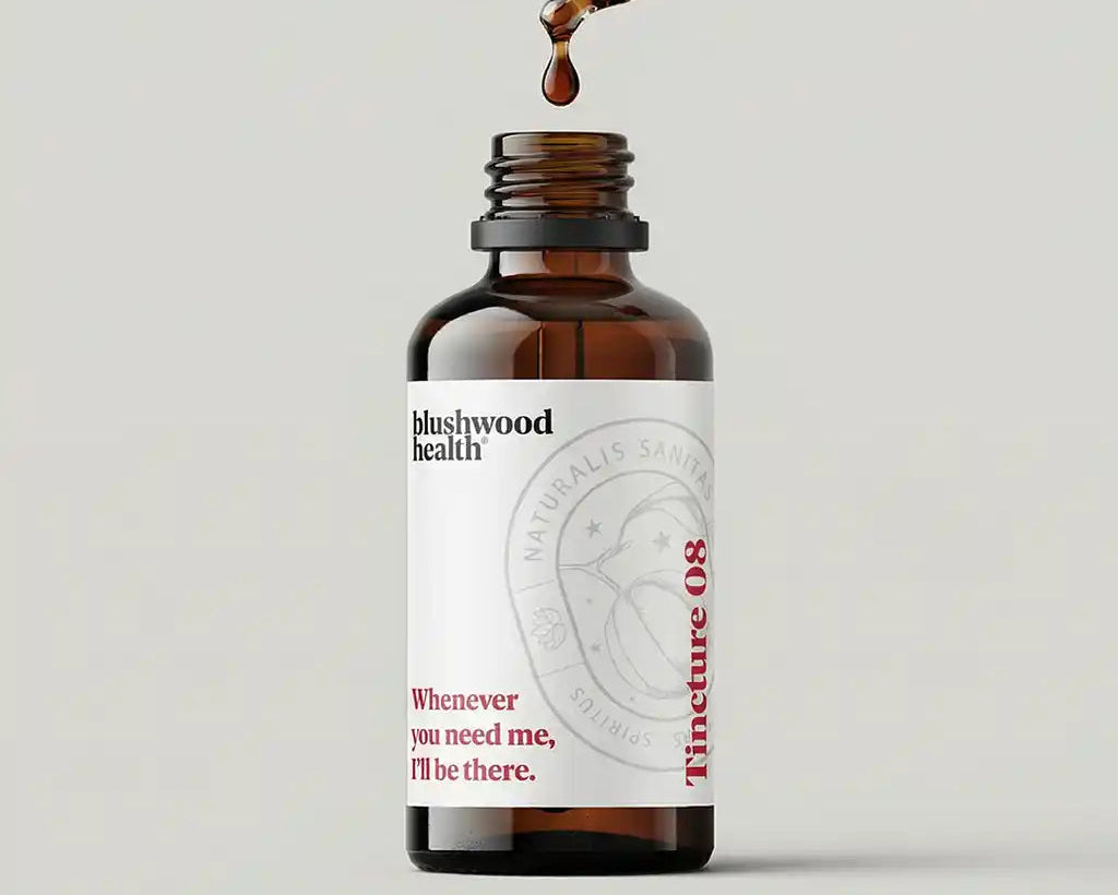 Brown bottle with dropper labeled 'blushwood health' on a light gray background